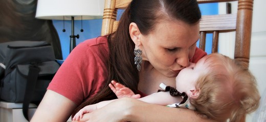 Mother kisses her baby