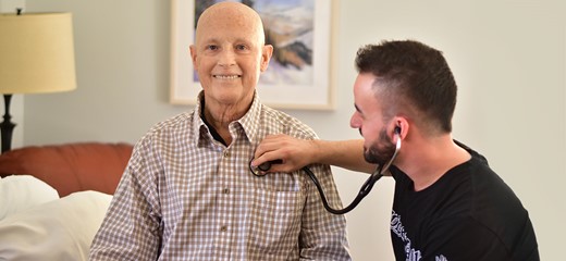 John Hardinson Nurse takes heart rate of patient