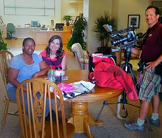 Cameraman shooting video of two females