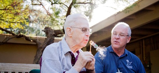 Hospice of the Valley volunteer blows bubbles with a person with dementia. 