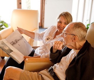 Volunteer reading to patient