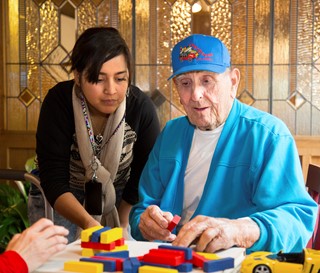 Volunteer works with a person with dementia