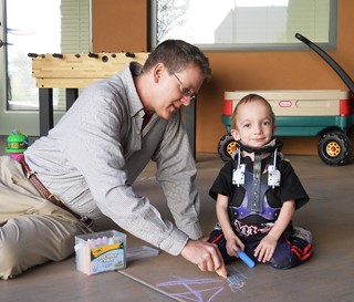 Volunteer plays with a Ryan House patient