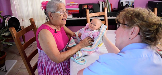 Quiet moments volunteer with elderly patient playing with doll