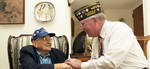 Salutes volunteer shakes hands with a veteran patient