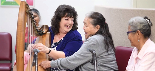 PIMC Music therapy harpist performs for patients