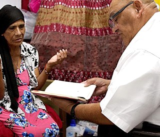 Cristiano Artigas visits patient Maria Estrada Hernandez at her west Phoenix home