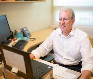 Chaplain Bob Barrett working at desk