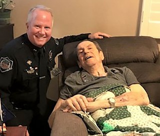 Hospice of the Valley volunteer and Mesa police Cmdr. Bill Peters visits with Walter Schutt, a former police chief.