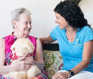 Physician comforts patient with toy dog