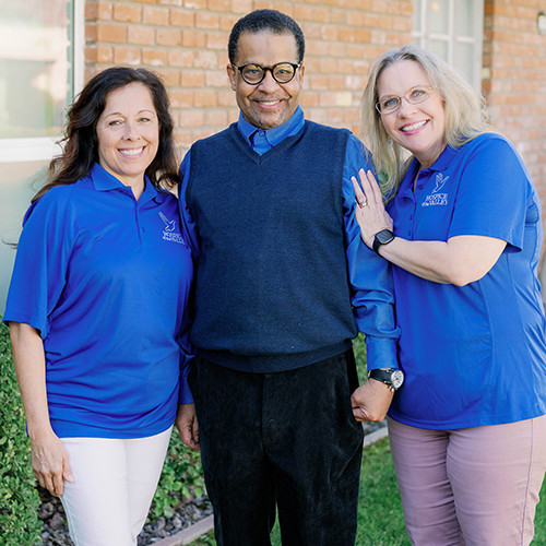 Two nurses caring for a patient at home